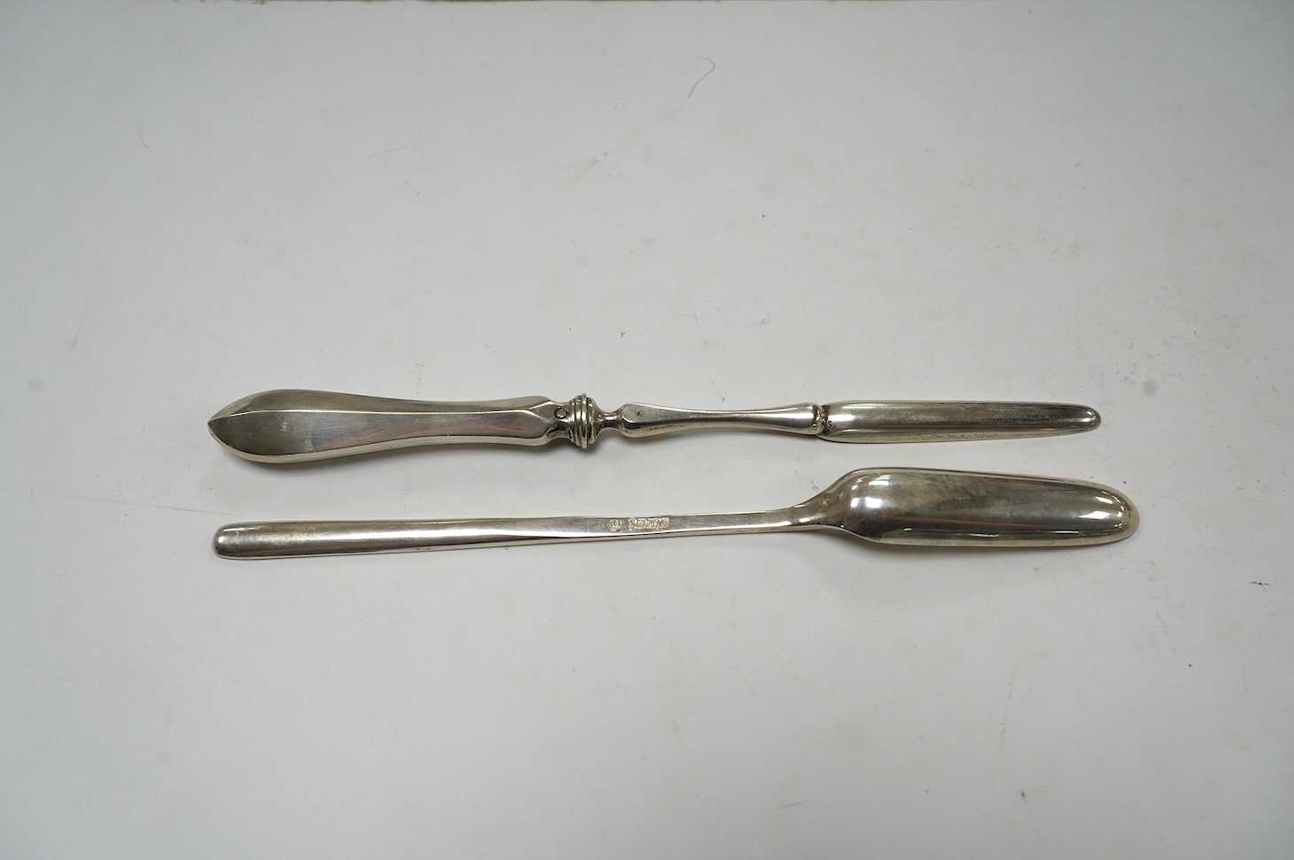 An Elizabeth II silver marrow scoop, by Francis Howard Ltd, Sheffield, 1977, 21.6cm, together with a Dutch 833 standard white metal marrow scoop. Condition - fair